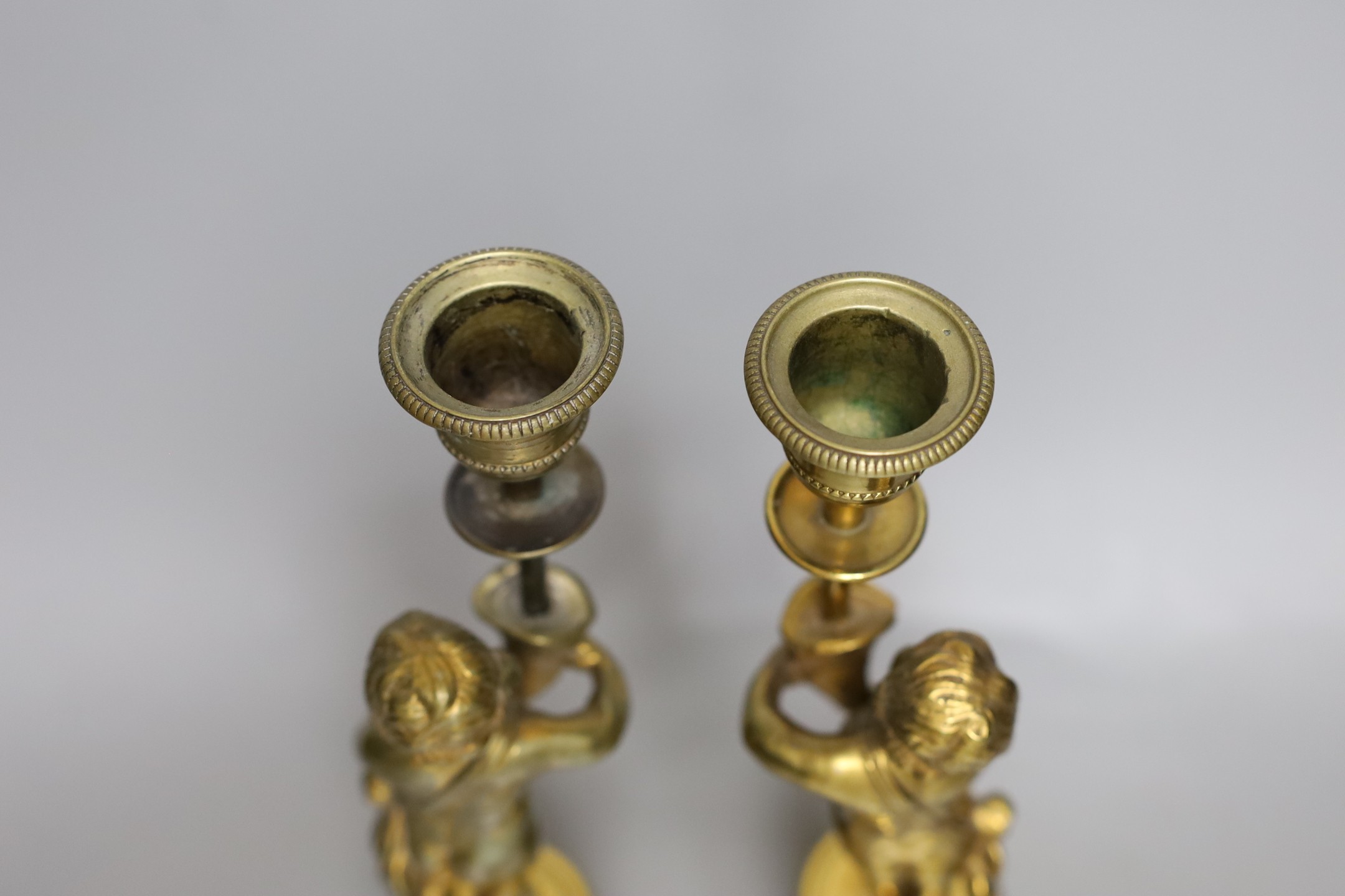 A pair of early 20th century gilt brass figural candlesticks, 27.5cm